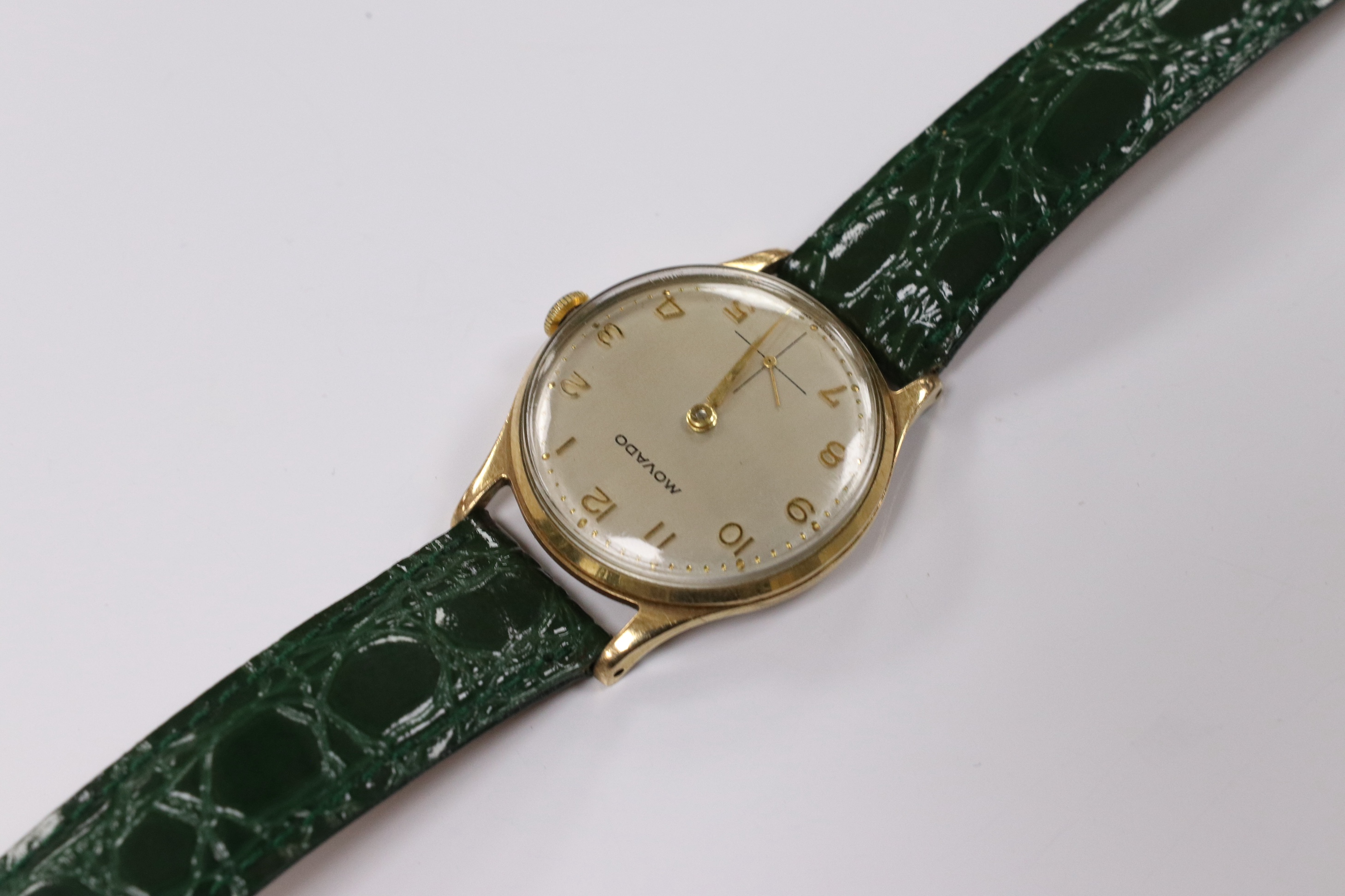 A gentleman's 1950's 9ct gold Movado manual wind wrist watch, with Arabic dial, subsidiary seconds and case back inscription, case diameter 31mm, on a later associated leather strap. Condition - fair